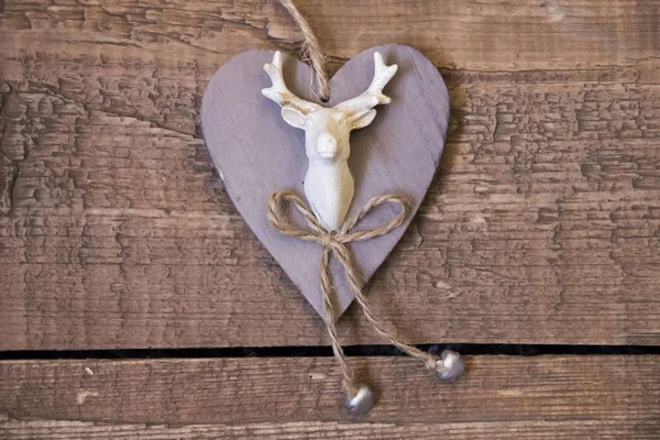 Beige wooden heart with picture of deer on boards — Stock Photo, Image