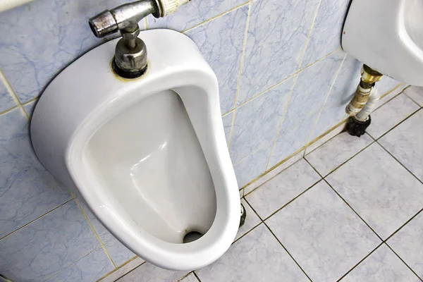 White porcelain urinals in public toilet — Stock Photo, Image