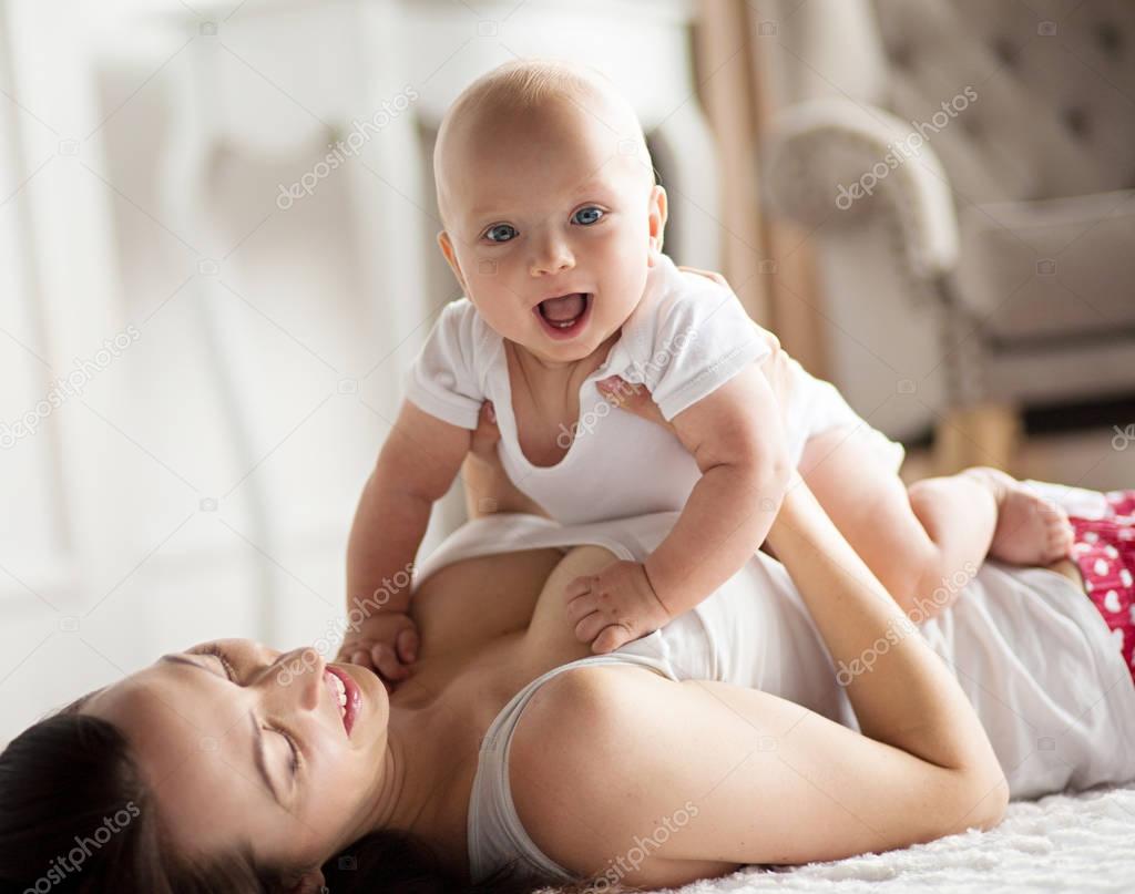 Young mother playing with her baby.