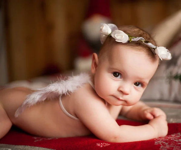 Portrait of small baby in angel costume and wreath of roses on her head. — Stock Photo, Image