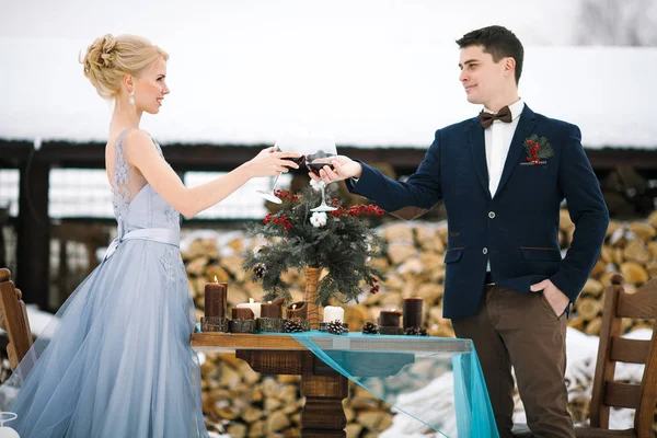 Winter wedding outdoor on table and firewood background. — Stock Photo, Image