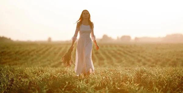 Jeune femme en longue robe en dentelle blanche sur champ de maïs . — Photo