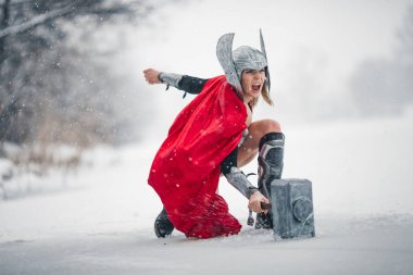 Furious woman in image of Germanic-Scandinavian God of thunder and storm. Cosplay. clipart