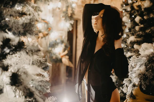 Mujer bonita se levanta contra el fondo de las decoraciones de Navidad . — Foto de Stock