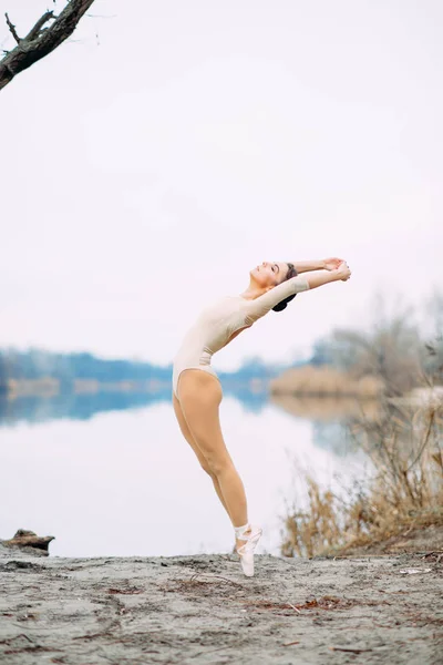 Bailarina baila en la orilla del lago . — Foto de Stock