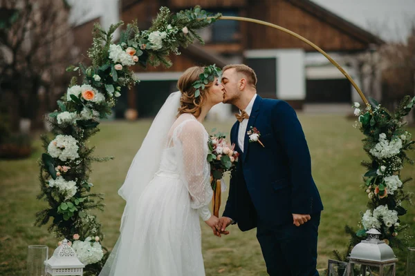 Newlyweds Stand Background Wedding Arch Hold Each Other Hands Kiss — Stock Photo, Image