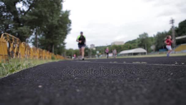 Running in the stadium. People go in for sports at the stadium. Background, wallpaper. Out of focus. — Stock Video