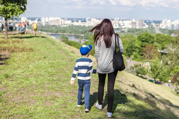 Moeder houdt een hand van zijn zoon in de zomer dag buiten Rechtenvrije Stockfoto's