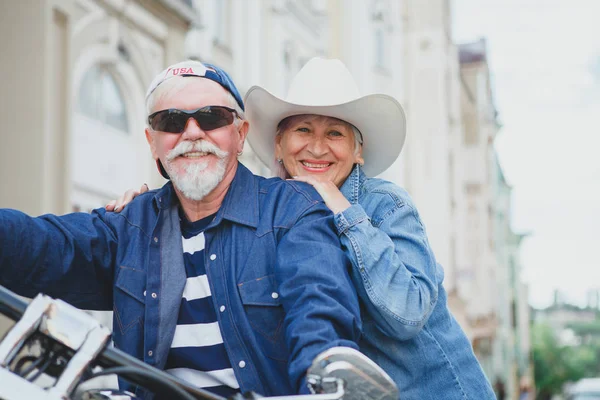 Mature man and woman on a motorcycle. Stock Picture