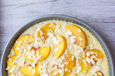 Gri bir ahşap zemin üzerine kayısı badem pasta