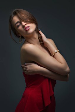 Kırmızı Eegant kız. Onun boynunu alır. Drama. Kavram portre stüdyo.