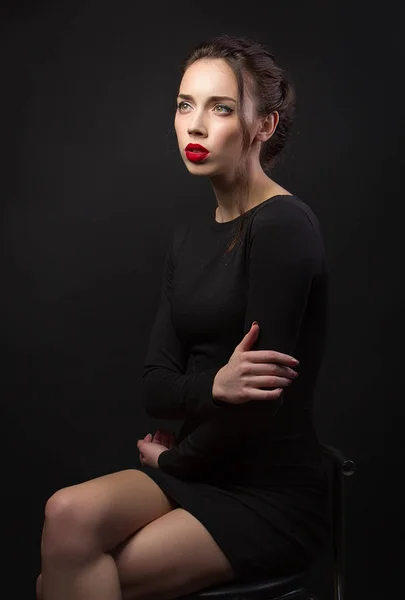 Portrait brunette girl in black dress. Red lips. Fashion — Stock Photo, Image