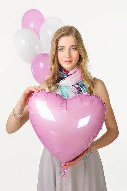 Bahar bakmak pembe Balonlu Sepet kalbi olan kız. Sevgililer günü