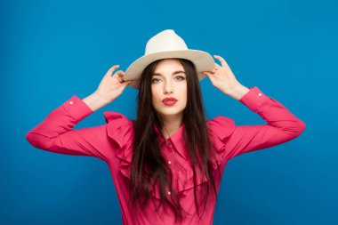 Şapkalı güzel bir kadın. Retro moda. Mavi arka plan.