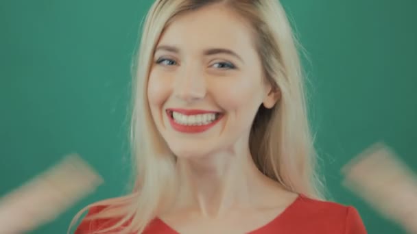 Closeup Portrait of Young Surprised Woman with Red Sensual Lips. Cute Blonde with Long Hair Grimacing on Green Background in Studio. — Stock Video