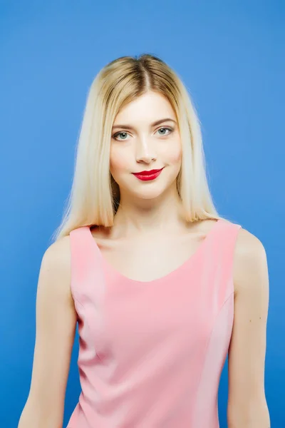 Amazing Blond-haired Woman with Professional Makeup in Studio. Portrait of Beautiful Girl on Blue Background. — Stock Photo, Image