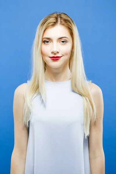 Portrait of Attractive Blonde with Long Hair Wearing Elegant Dress Posing on Blue Background in Studio. — Stock Photo, Image