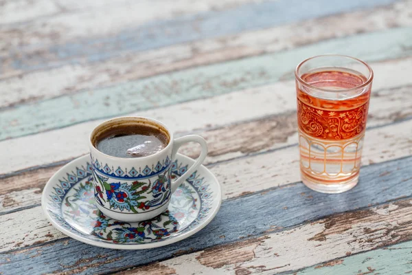 Turkish coffee in traditional cup with glass of water on vintage table — Stock Photo, Image