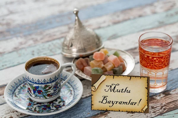 Happy eid text in turkish on greeting card with turkish coffee, delights — Stock Photo, Image