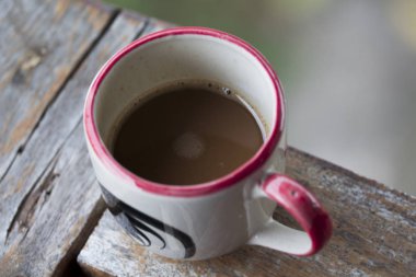 Yeşil arka plana sahip kahve kupa