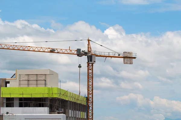 Image of yellow tower cranes construction with blue sky, tower c