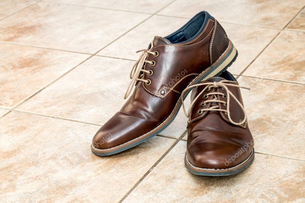 Pair of fashion brown men's shoes with shoestring