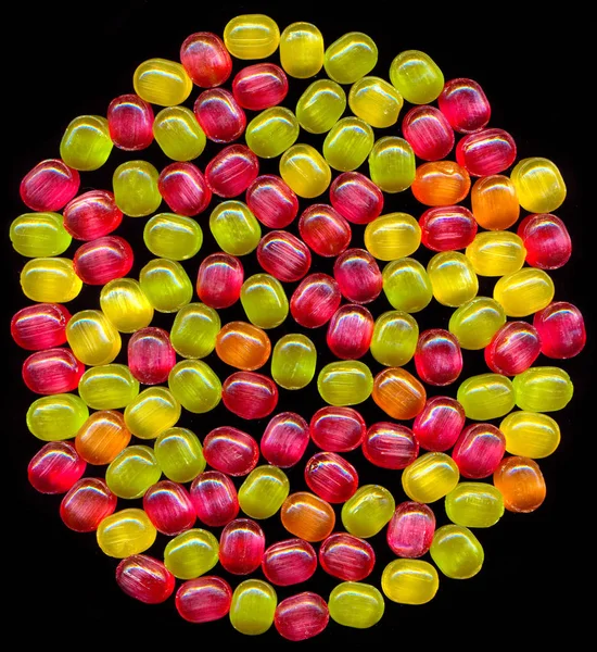 Jasné barevné sladké cukroví, samostatný na černém pozadí. — Stock fotografie