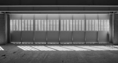 Shadow and light. Black and white. Sunny day light from metal lattice in abandoned unfinished shoping mall clipart