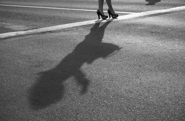 Two modern girls on high heels stand on sunny asphalt — Stock Photo, Image