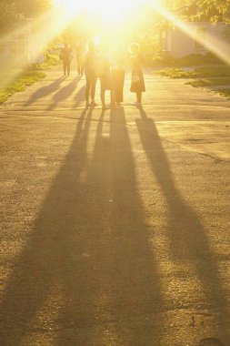Güneşli ışınları, kızlarda gölgeler günbatımı Zamanı. 
