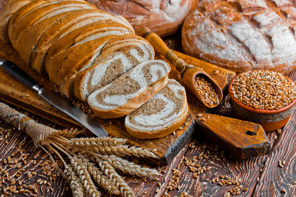 Wheat bread on the old background