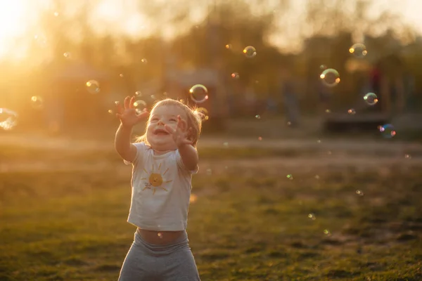 Kleine Lachende Jongen Speelt Met Zeepbellen Een Open Plek Bij — Stockfoto