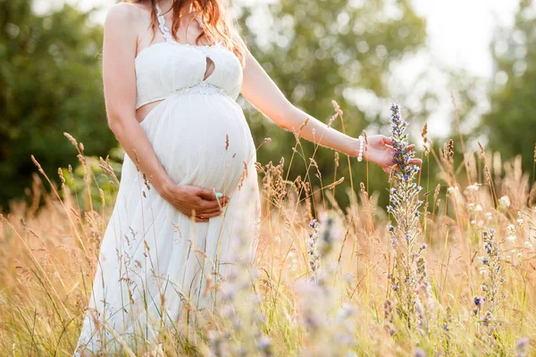 Hermosa mujer embarazada relajándose fuera en el campo — Foto de Stock