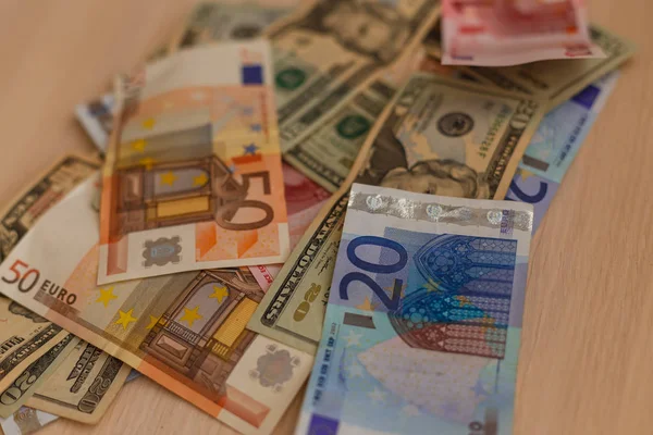 Cash dollars couchés sur l'avion et euros la table — Photo