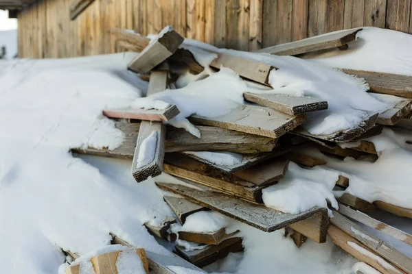 Stelletje planken bedekt met sneeuw. Frosted houten planken in de winter buiten blijven. Koude, vroege vorst, hoar concept — Stockfoto