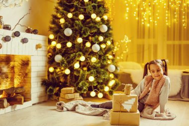 Güzel genç kız Noel 'i düşlüyor, arkasında Noel ağacı