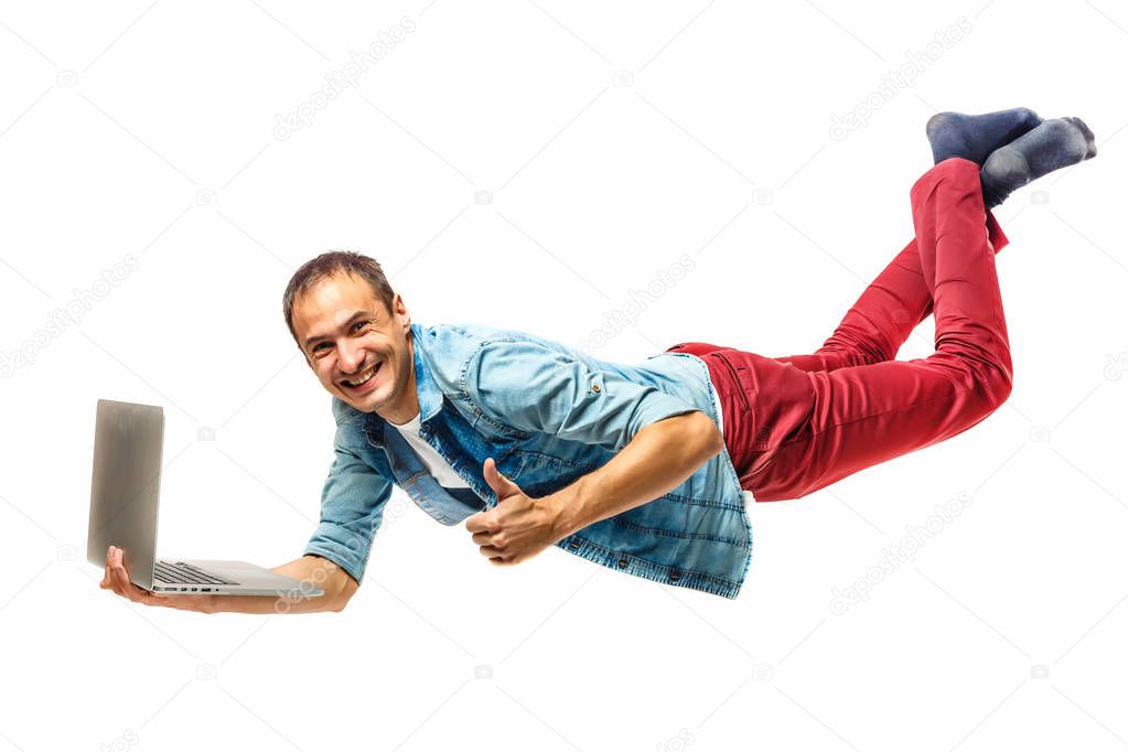 Young hipster man with laptop in the air. isolated on white. Concept communication.