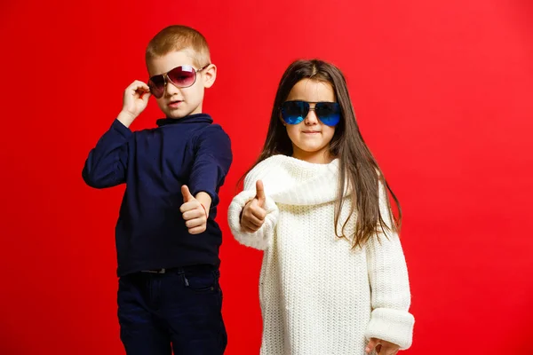 Two Happy Funny Kids Standing Together Embracing Isolated Red — 스톡 사진