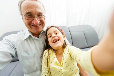 Grandfather and granddaughter spending time together  clipart