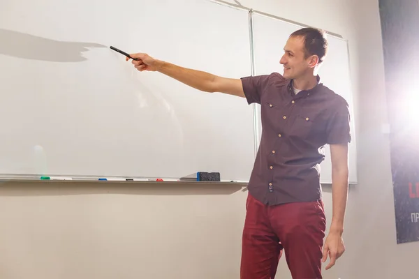 man teacher near blackboard