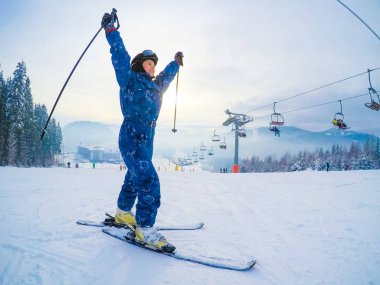 Tepedeki Tom 'da kayak yapan genç bir kadın.
