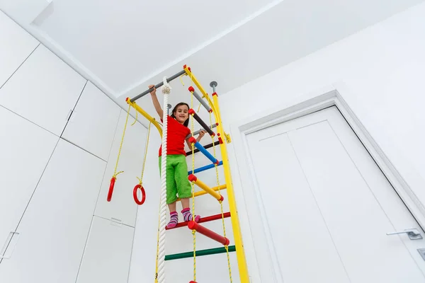 Beautiful Athletic Girl Plays Sports Wall Bars Children Room — Stock Photo, Image
