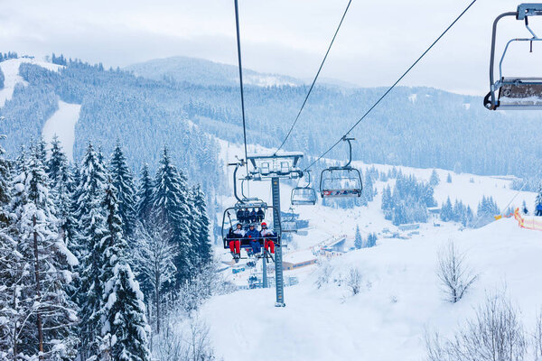 friends on ski lift at ski resort