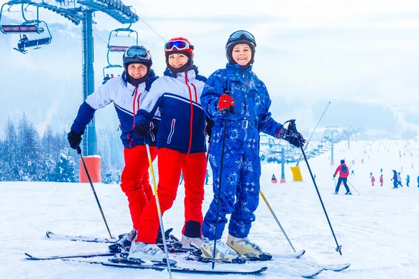 Grupo de amigos com esqui andando em uma estância de esqui — Fotografia de Stock