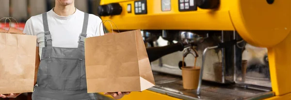 delivery, mail and people concept - happy man delivering food in disposable paper bag to customer home