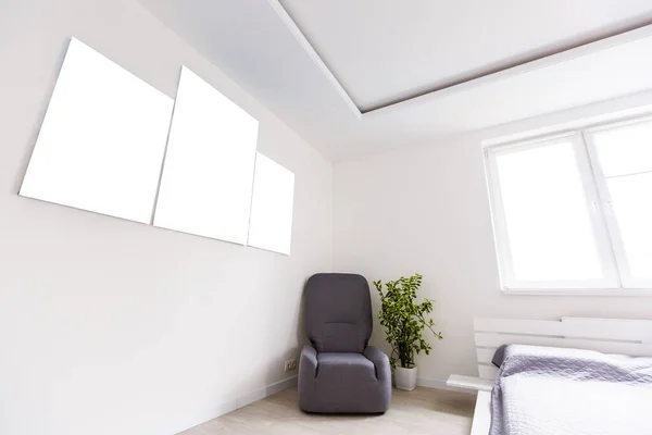 Mockup photo canvas in interior. Empty canvas for design. White brick wall on background.