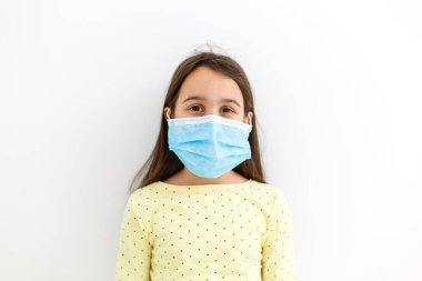 Maskeli çocuk, grip virüsüne karşı koruma. PM2.5 'i korumak için maske takan küçük beyaz kız. Biyolojik silahlar. Gri arka planda fotokopi alanı olan bir bebek. Salgın, salgın.