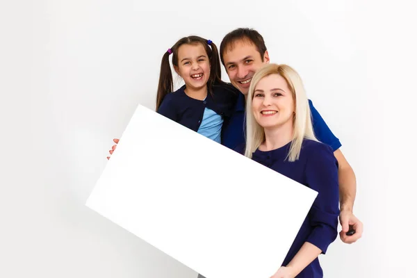 Family holds photo canvas at home — стоковое фото