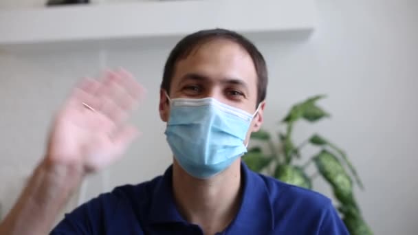 Ein Mann im blauen Hemd maskiert das Coronavirus — Stockvideo