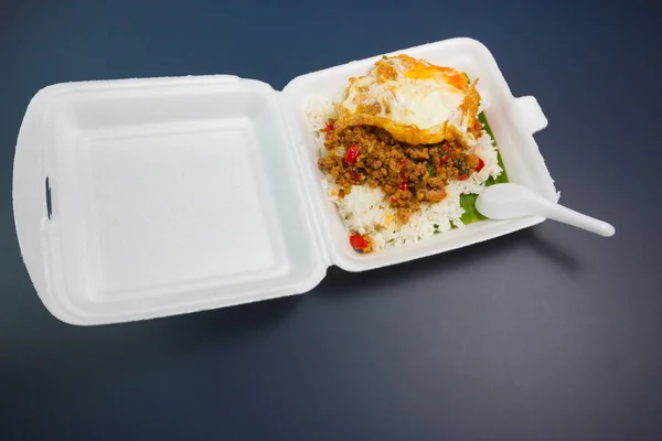 Rice topped with stir-fried pork and basil Stock Photo
